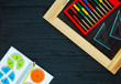Colorful math fractions on dark wooden background or table. Interesting math for kids. Education, back to school concept. Geometry and mathematics materials. Mental math.