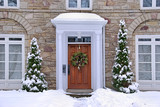 Fototapeta Do pokoju - stone fronted house with snow and wreath on front door