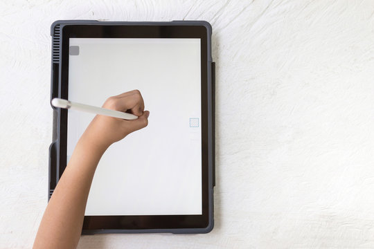 Hands of Children drawing with digital pen on the tablet, image with copy space.