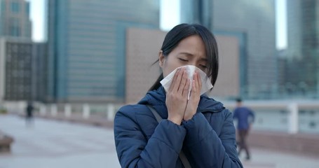 Wall Mural - Woman sneezing at outdoor