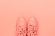 Pair Of Coral Shoes On Coral Background. Trendy Color Of 2019. Monochrome Image.