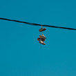 Sneakers hanging on a sky background. The concept of urban kultruta, sale of prohibited substances, ghetto