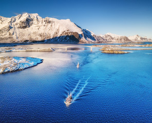 Canvas Print - Aerial view of fishing boats, bridge, mountains and ocean. Boats on the Lofoten islands, Norway. Ocean and mountains in The Norway. Travel image in Norway.