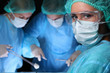 © rogerphoto - Closeup of surgeons performing operation. Focus on female nurse. Medicine, surgery and emergency help concepts