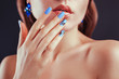 Beautiful woman with perfect make-up and blue manicure wearing jewellery. Nail design. Beauty and fashion concept.