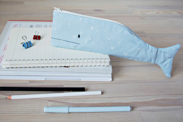 Wall Mural - Whale pencil case, notes and pens on the wooden desk