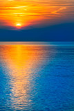 Fototapeta Natura - Gorgeous End of Day at the Sea / Natural spectacle - colorful blue and orange reflecting sunset at sea horizon (copy space)