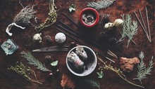 Various Air Element Objects To Use In Witchcraft And Wicca On A Witch's Altar Filled With Evergreens Dried Herbs Sage Incense Sticks For Smoke Cleansing