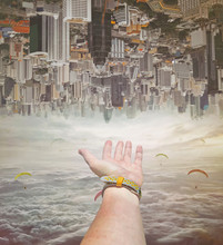 Closeup View Of A Hand Of  A Person  In Sky Of Clouds . Invert  City Upside Down .Future Modern Business Industry Concept: Big City On Amazing Sky  At Bangkok, Thailand, Asia