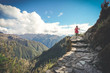 © Grovic - A female hiker is walking on the famous Inca trail of Peru with walking sticks. She is on the way to Machu Picchu.