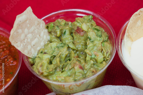 Fotografie, Obraz Tortilla Chip in a cup of Guacamole Mexican Food