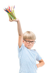 Isolated child with pencils. Adorable kid on white background. Portrait of funny blonde boy with colorful pencils.