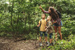 © BalanceFormCreative - Mother and her little sons hiking trough forest .They learning about animal and plant life.