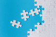 © Yeti Studio - White puzzle pieces on blue background