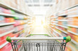© nonnie192 - Supermarket aisle with empty green shopping cart