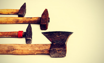 Set of vintage hand construction tools on a white wooden background .