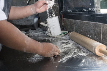 Wall Mural - Hands preparing a pizza in the kitchen