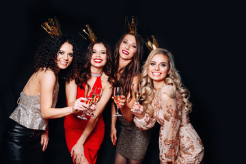 Four young beautiful women together celebrating party