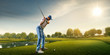 Male golf player on professional golf course. Golfer with golf club taking a shot