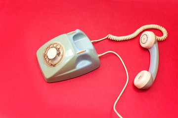 old retro phone isolated on red, pink background