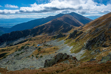 rocky Tatra mountain tourist hiking trails under blue sky in Slovakia