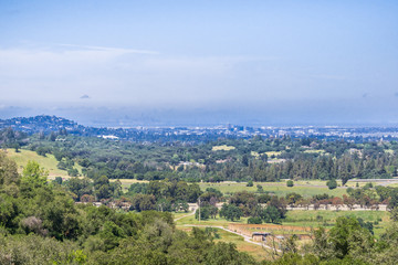 Wall Mural - View towards Redwood City, San Francisco financial district can be seen through the haze in the background, San Francisco bay area, California