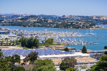 Wall Mural - Aerial view of the bay and marina from the hills of Sausalito; solar panels installed on the rooftop of a building, San Francisco bay area, California