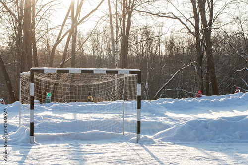 Fotografia Empty football gate on the field powdered by snow