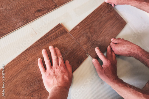 Workers Are Making Laminate Flooring In Apartment Maintenance