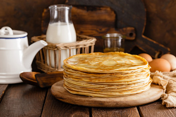 Wall Mural - Homemade thin crepes with honey, pancakes on wooden rustic background