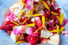 Macro Closeup Of Colorful Bowl Of Ice Cream Topped With Vibrant Pink Rose Flower Petals, Red Raspberries, Fruit Salad, Dessert