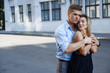 © Skripnik Olga - couple in love embraces against the backdrop of a building in the city, smiling, attracted. date, love Valentine's Day