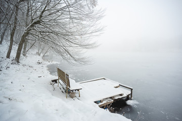 Wall Mural - Pier on frozen winter lake in the fog