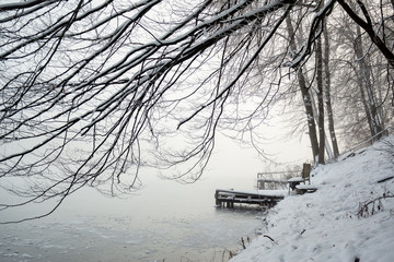 Wall Mural - Pier on frozen winter lake in the fog