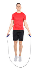 Canvas Print - Full length portrait of young sportive man training with jump rope on white background