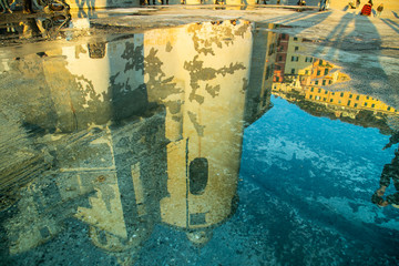 Wall Mural - Basilica Santa Maria Assunta reflected on a sea water puddle in Camogli