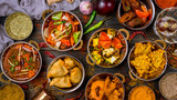 Fototapeta  - Assorted indian food set on wooden background. Dishes and appetisers of indeed cuisine, rice, lentils, paneer, samosa, spices, masala. Bowls and plates with indian food