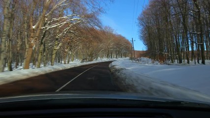 Wall Mural - Driving a car, snowy landscape