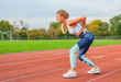 © Dmytro Flisak - Back pain. Athletic woman on running track touching back with painful injury