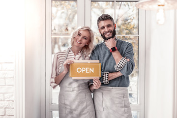 Delighted cheerful young couple smiling to you