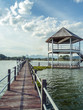 Long wooden bridge to big pavilion over the lake at Huay Mai Tai, Hua Hin, Thailand.