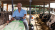 © JackF - Man proffesional farmer  is sitting in the car near cows at the cow farm