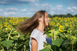 © AnastazjaSoroka - Young girl dances in a field of sunflowers.