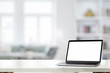 © bongkarn - Mockup laptop on white desk at home