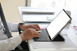 © bongkarn - Business man working on tablet computer on white desk in office