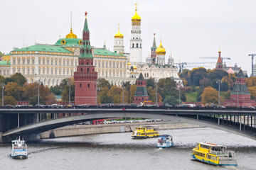 Beautiful view of the historical center of Moscow with Kremlin, Grand Palace, The Water Pump (Vodovzvodnaya) Tower and Bolshoy Kamenny Bridge and Moscow River embankment. Russia.