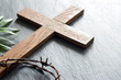 © udra11 - Easter wooden cross on black marble background religion abstract palm sunday concept