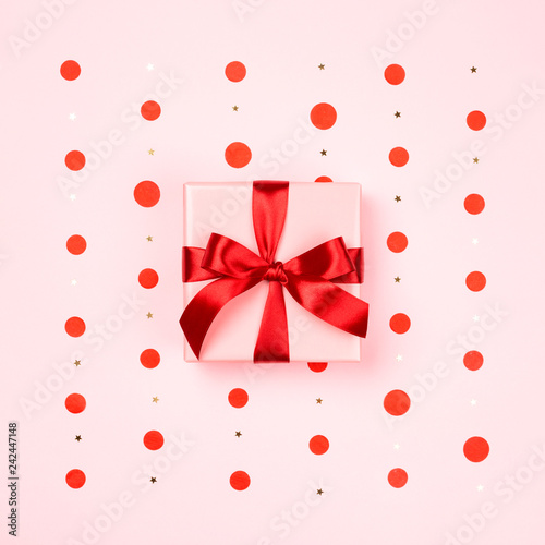Pink gift box with red bow.