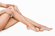 Leinwandbild Motiv Young woman touching silky skin on her legs
