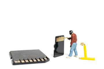 Wall Mural - Miniature people technician fixing pile of sd cards on white background with copy space.